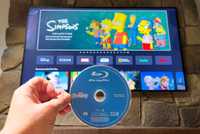 A Blu-Ray Disc in front of the Simpsons on streaming. 