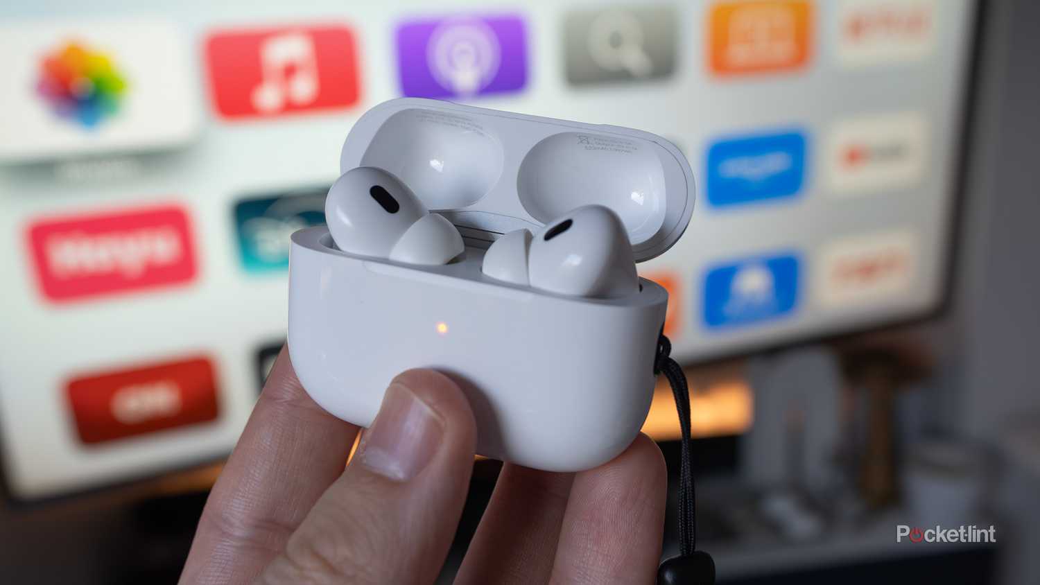 The AirPods Pro 2 in front of a TV.
