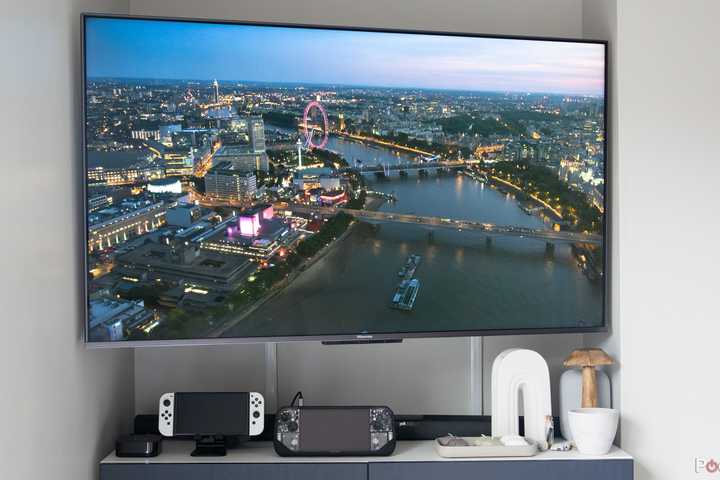 A TV with gaming handhelds and an Apple TV 4K.