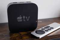 Apple TV 4K and remote on table.