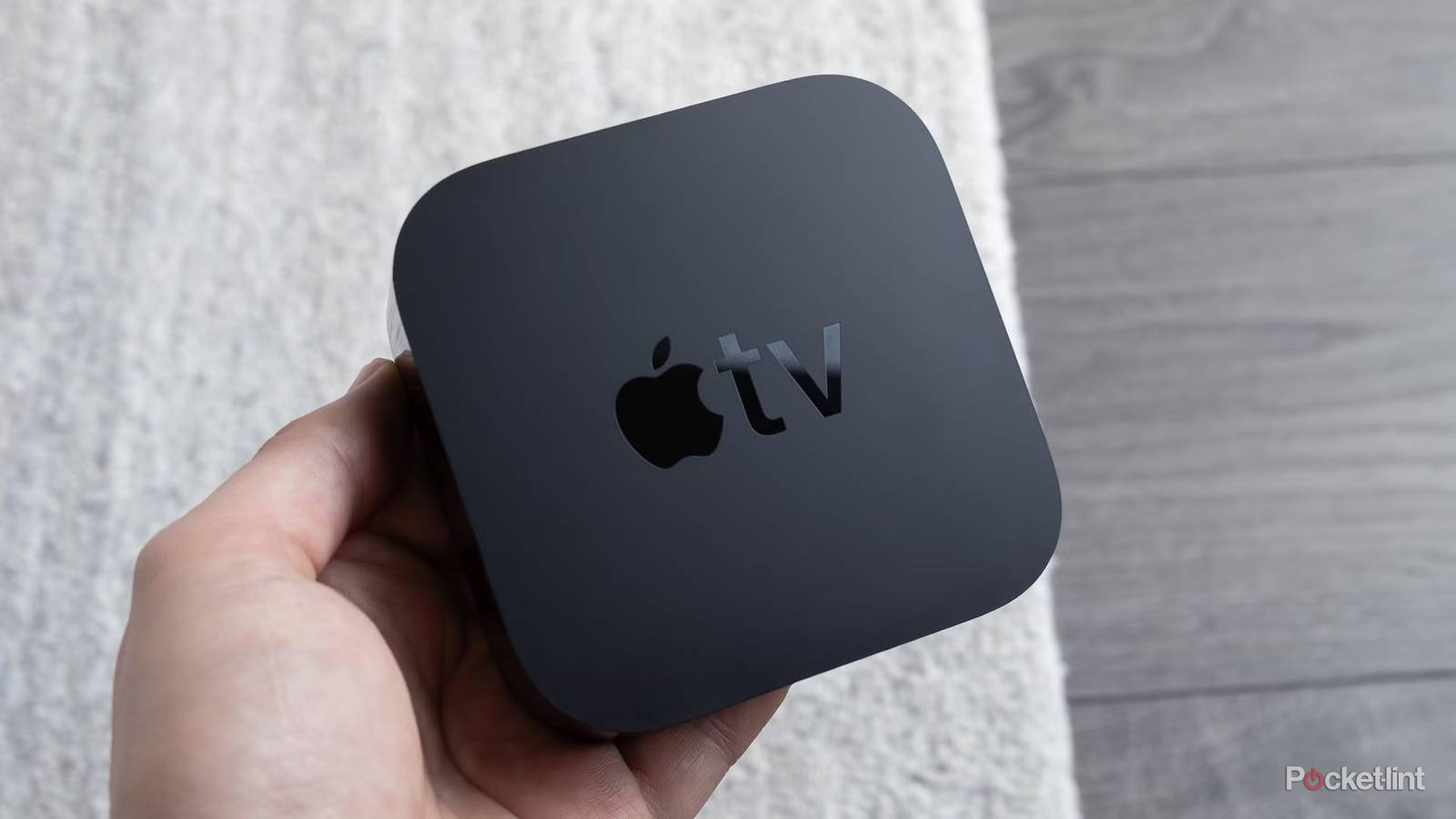 Person holding Apple TV 4K.