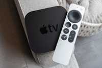 The Apple TV 4K (2021) and the Siri Remote sitting on a couch arm