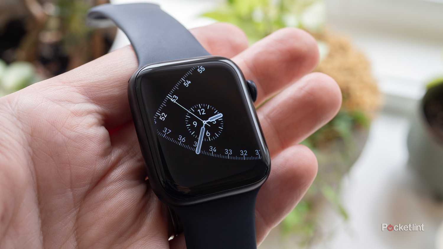 The Apple Watch SE 3 being held 