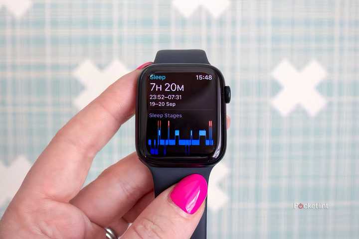 A hand holding an Apple Watch SE showing sleep tracking information.