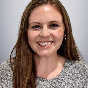 
Photo of white woman with Kansas shirt on smiling at camera
