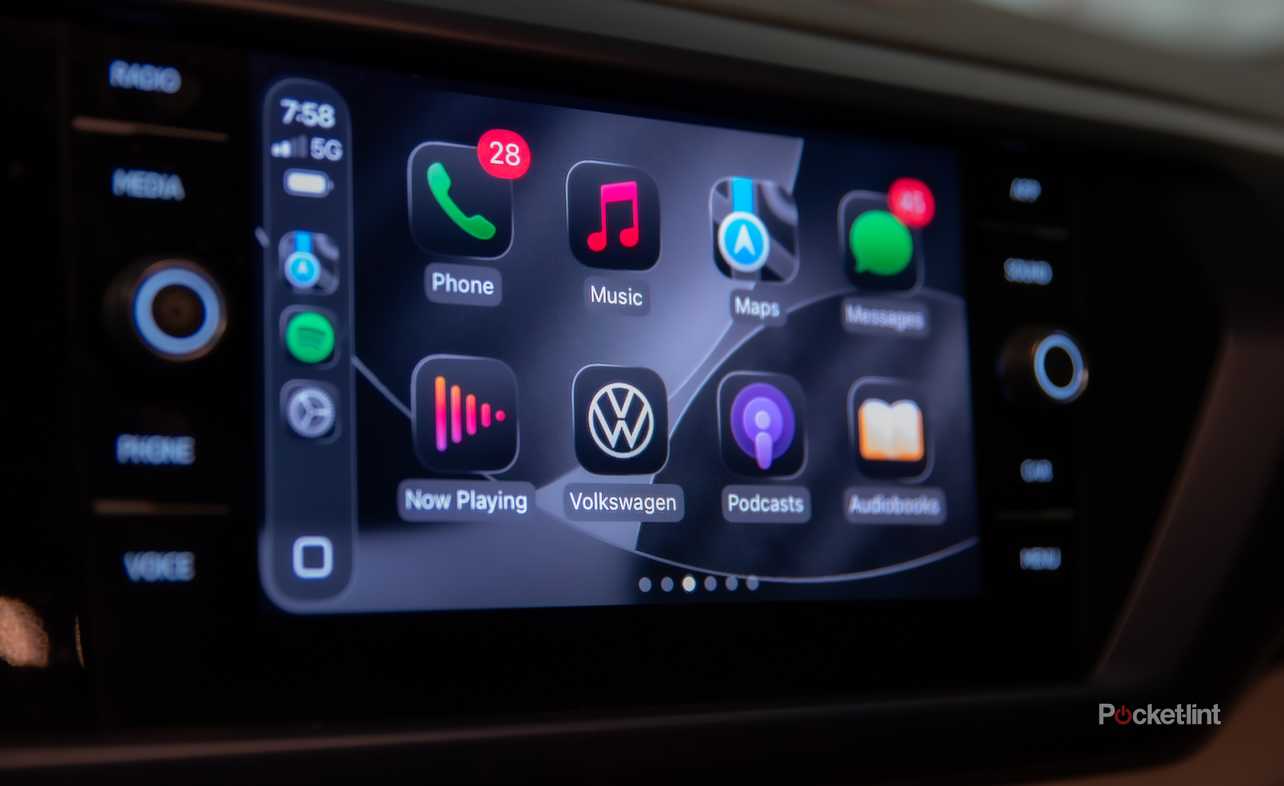A still photo of Apple CarPlay iOS 26 with apps in dark mode. 