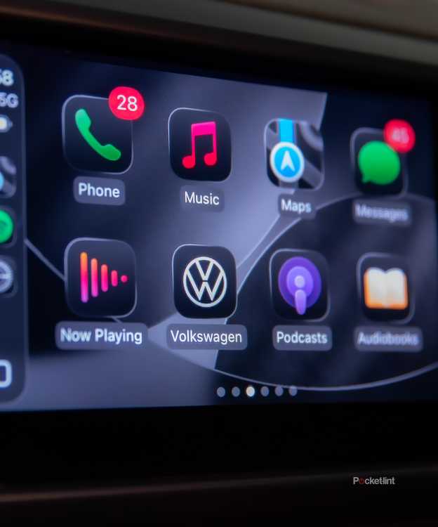 A still photo of Apple CarPlay iOS 26 with apps in dark mode. 