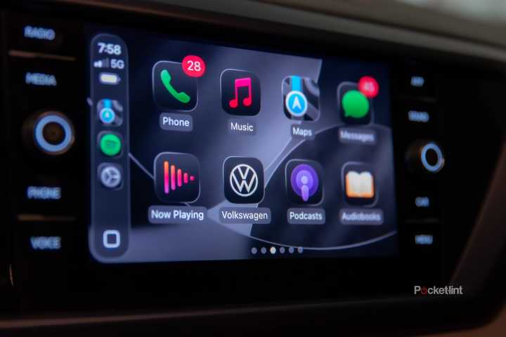 A still photo of Apple CarPlay iOS 26 with apps in dark mode. 