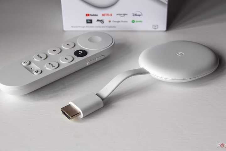 A Chromecast with Google TV sits on a white table.