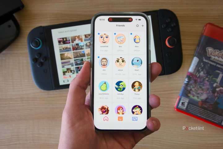 A hand holding an iPhone displaying the friends list in the Nintendo Switch App.