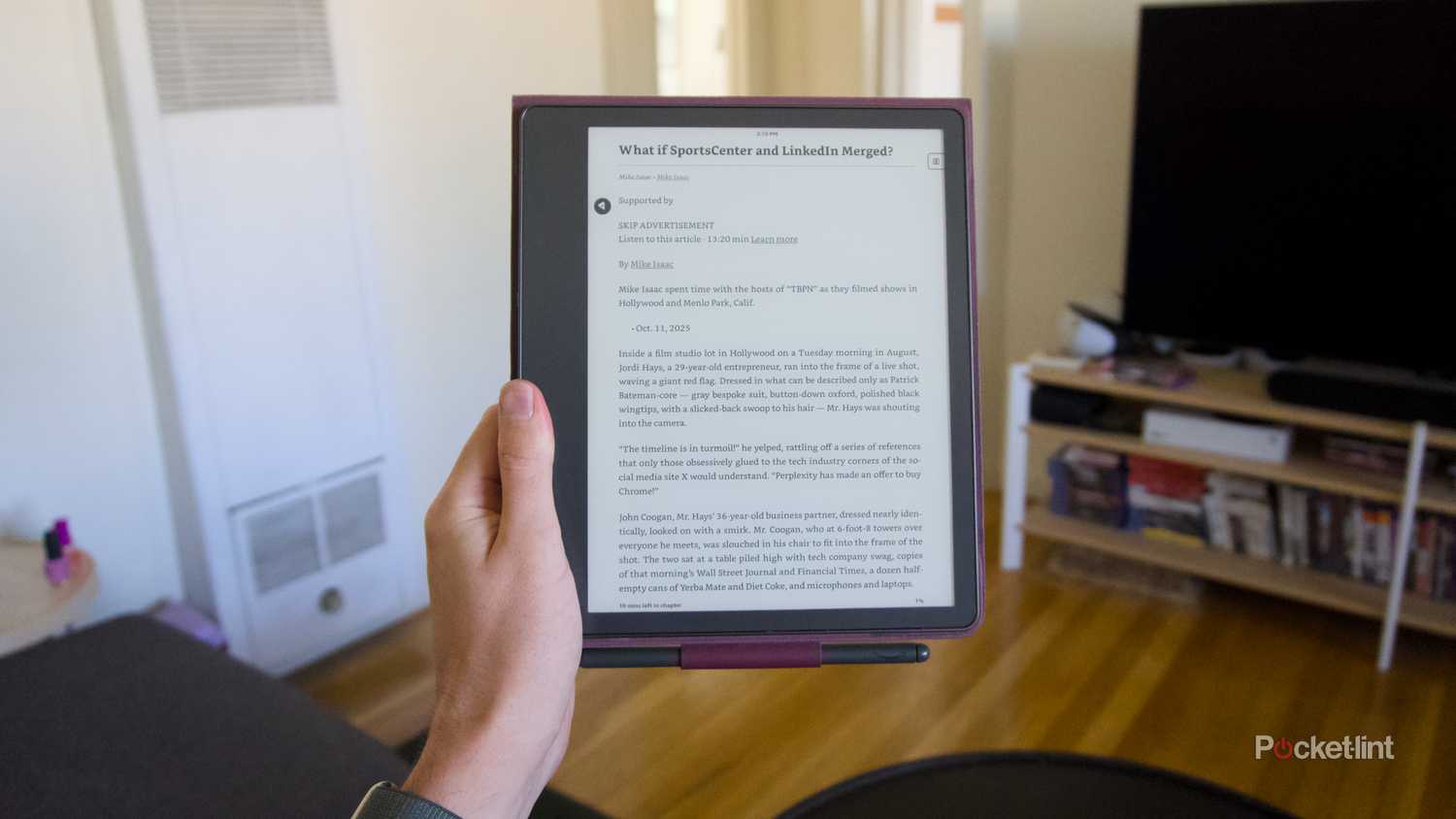 A hand holding a Kindle Scribe displaying an imported article.