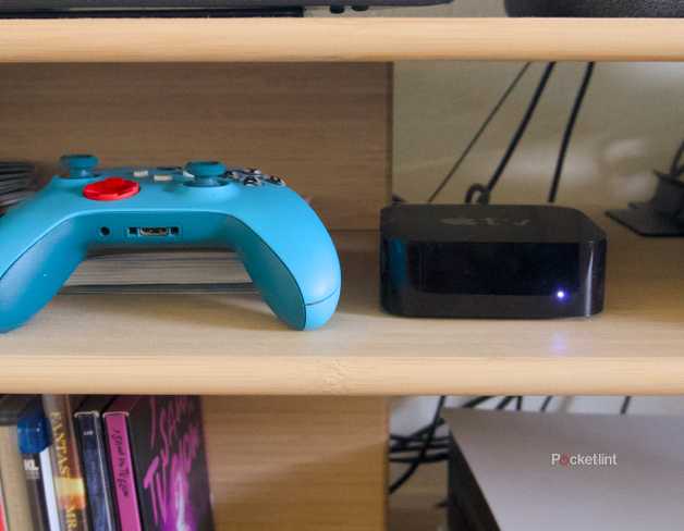 An Xbox game controller next to an Apple TV 4K.