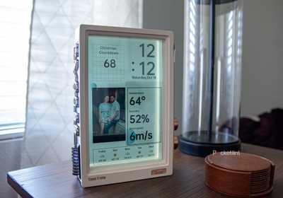A still photo of the Divoom Times Frame on an end table.
