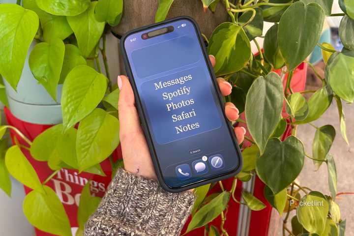 Kelsey holding a dumb iPhone. 