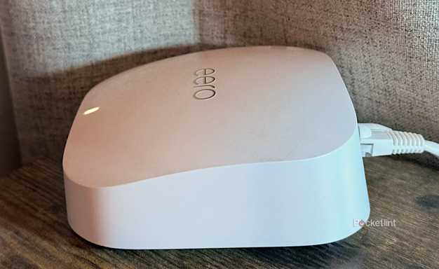 An Eero Pro 6E Wi-Fi router on a desk.