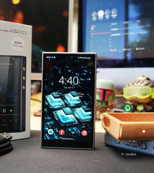 FiiO M21 on a desk with its packaging contents displayed around it.