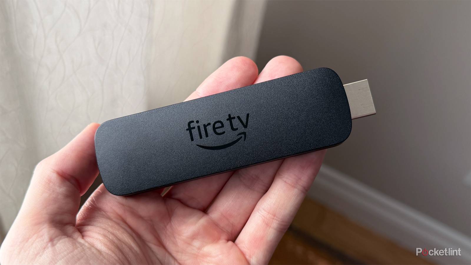 Person holding Fire Stick.