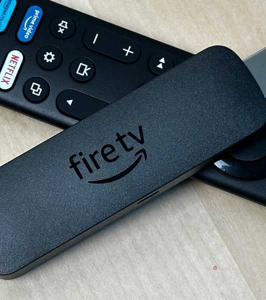 Amazon Fire TV Stick on top of remote.