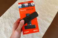 Fire TV Stick 4K box in hand with Fire TV Stick.