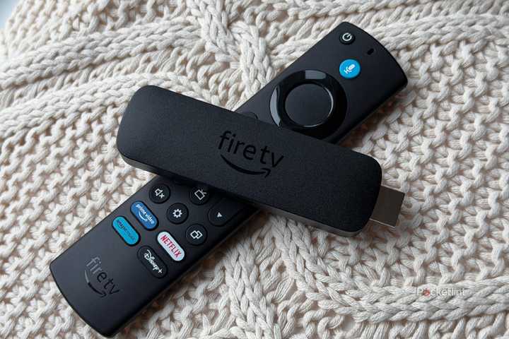 Fire TV Stick and Fire TV remote on knit pillow.