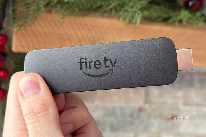 Person holding Fire TV Stick 4K Max.