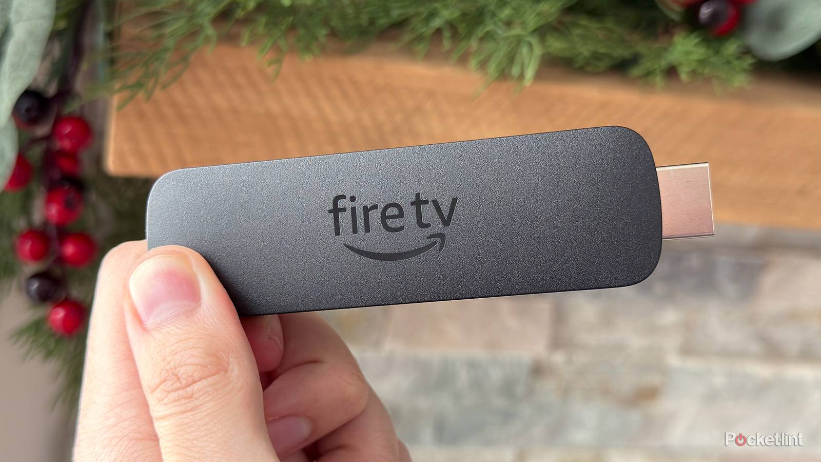 Person holding Fire TV Stick 4K Max.