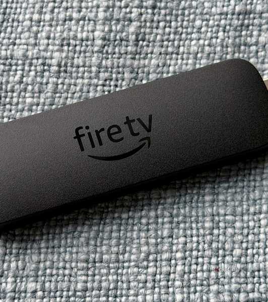 Fire TV Stick on blue pillow.