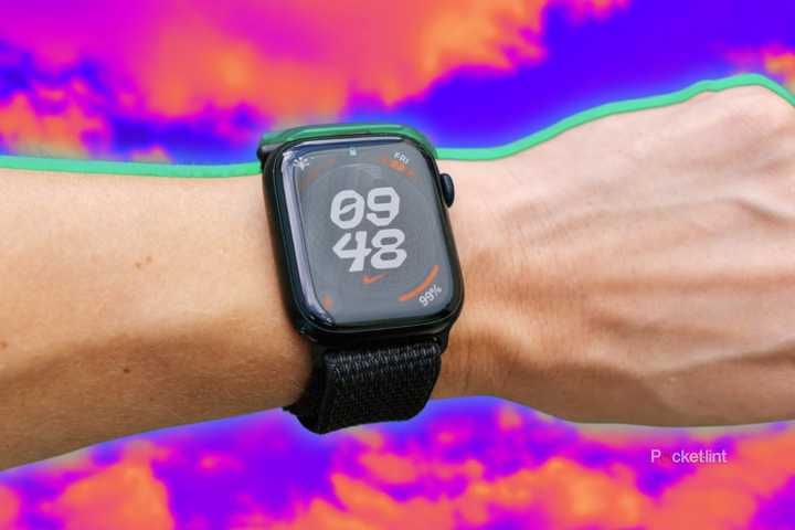 The Apple Watch on a wrist in front of a blurred sky background. 