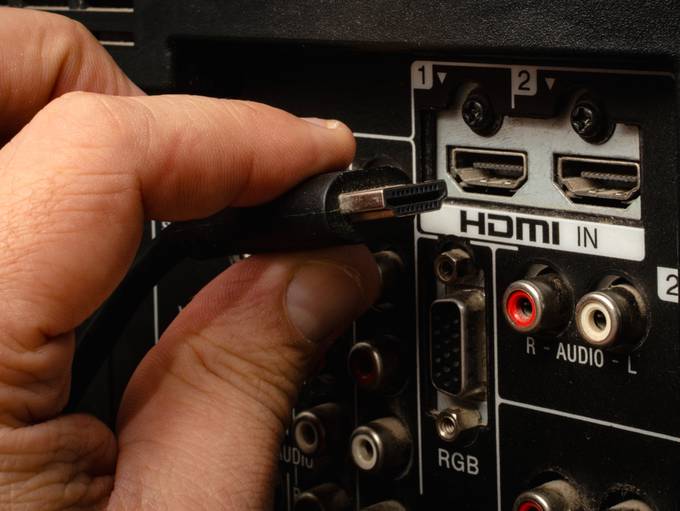 hdmi cable inserting into back of tv hdmi port