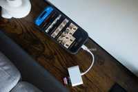 The iPhone 17 with a USB-C SD dongle plugged into it