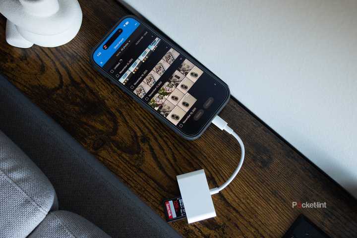 The iPhone 17 with a USB-C SD dongle plugged into it