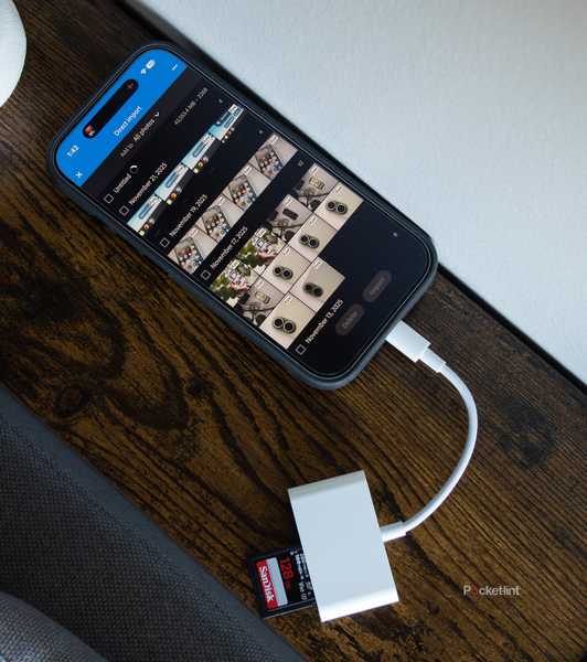 The iPhone 17 with a USB-C SD dongle plugged into it