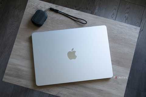 An M4 MacBook Air on a desk with earbuds.