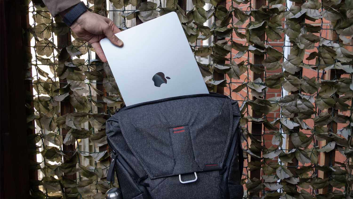 Putting an M4 MacBook Air into a backpack. 