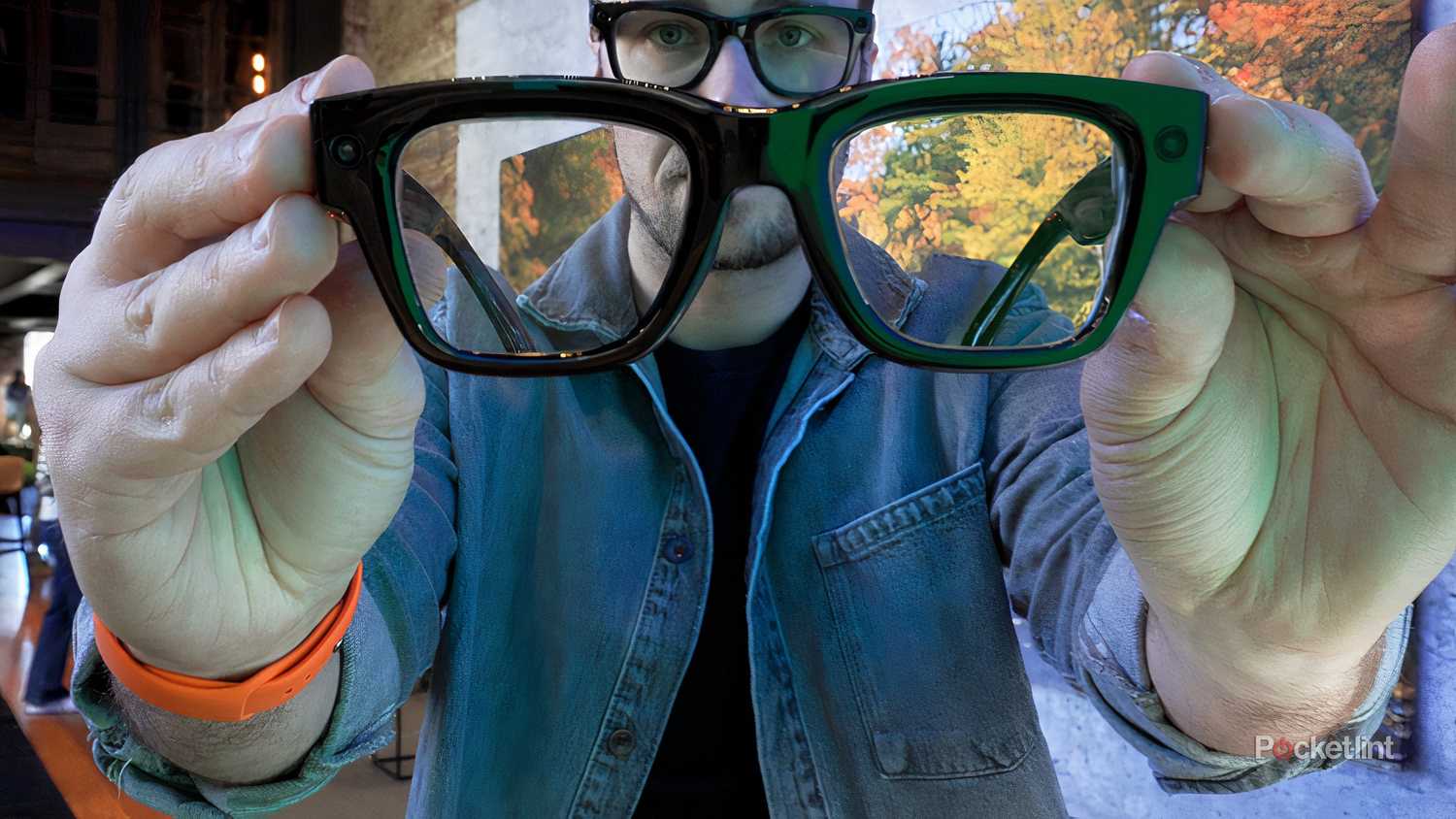 Holding up the Meta Ray-Ban Display.