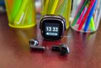 OSO AI Earbuds box and charging case on a table side