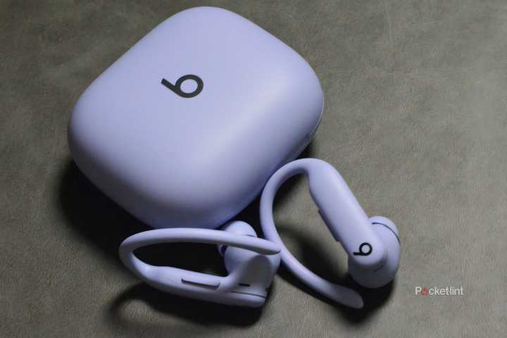 Powerbeats Pro 2 in purple beside their case. 