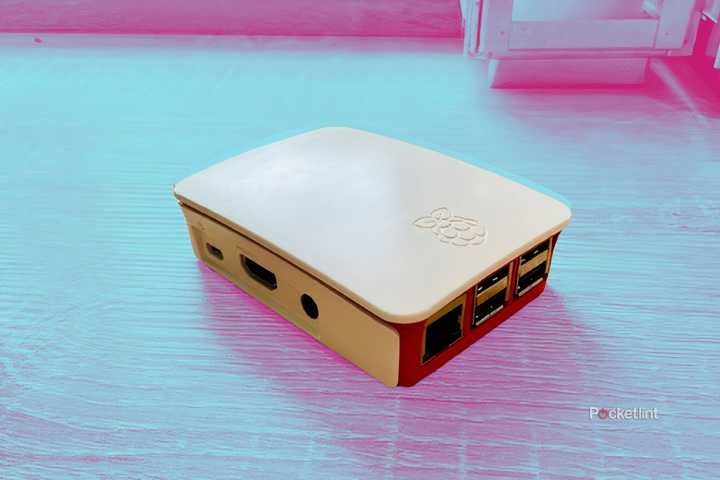 A Raspberry Pi 3B in the official case on a colored background.