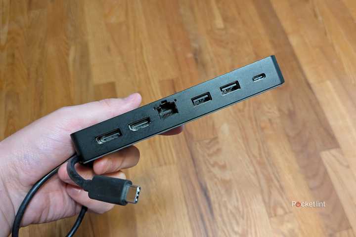 A person holding a USB-C hub.