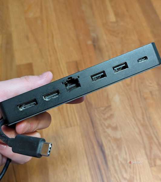 A person holding a USB-C hub.