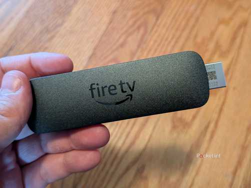 A person holding the Amazon Fire TV Stick 4K Select.