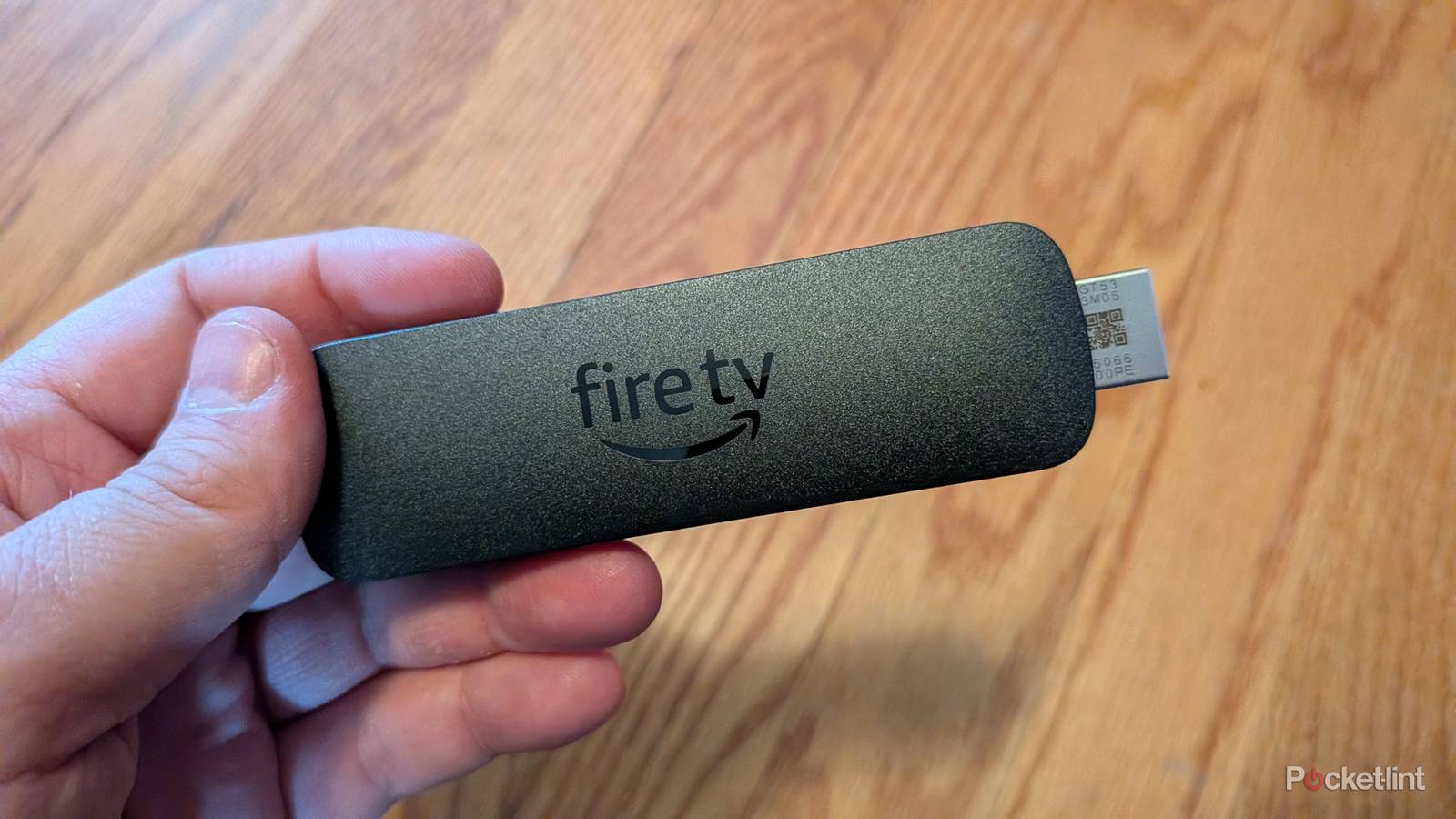 A person holding the Amazon Fire TV Stick 4K Select.