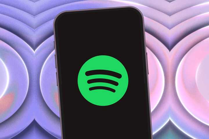Spotify app on iPhone with purple background.