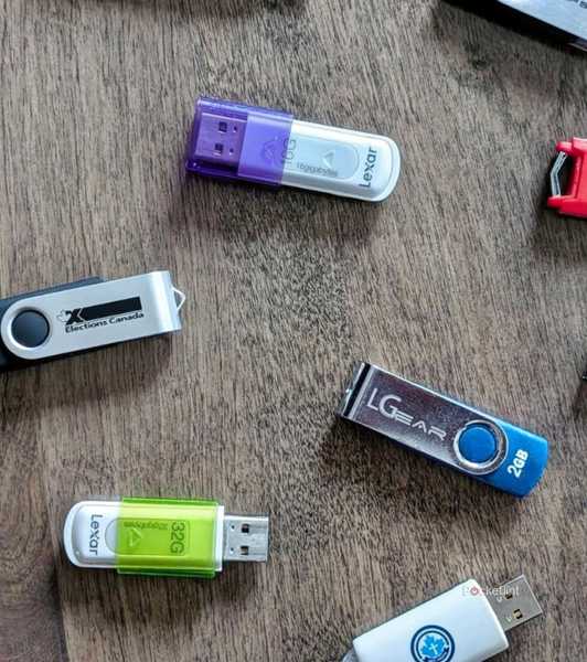 An assortment of USB flash drives on a table.