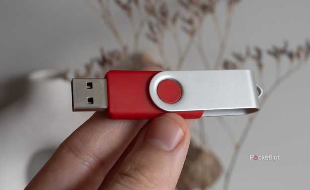 Holding a red USB stick 