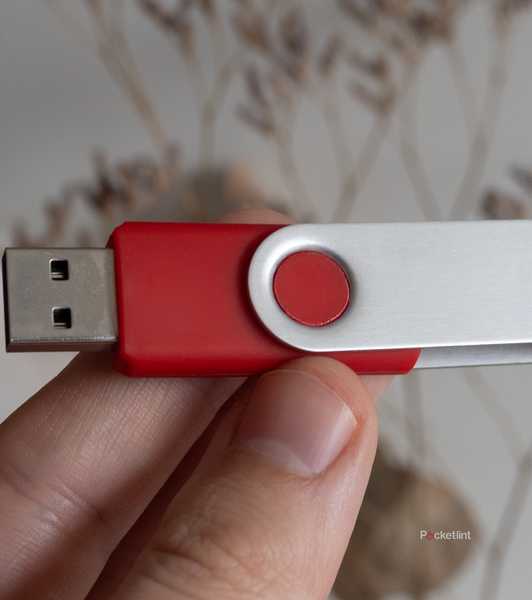 Holding a red USB stick 