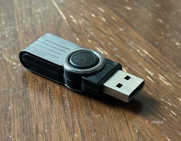 A USB stick on an old wooden storage box.