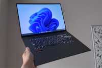 A Windows 11 laptop being held up in the air.